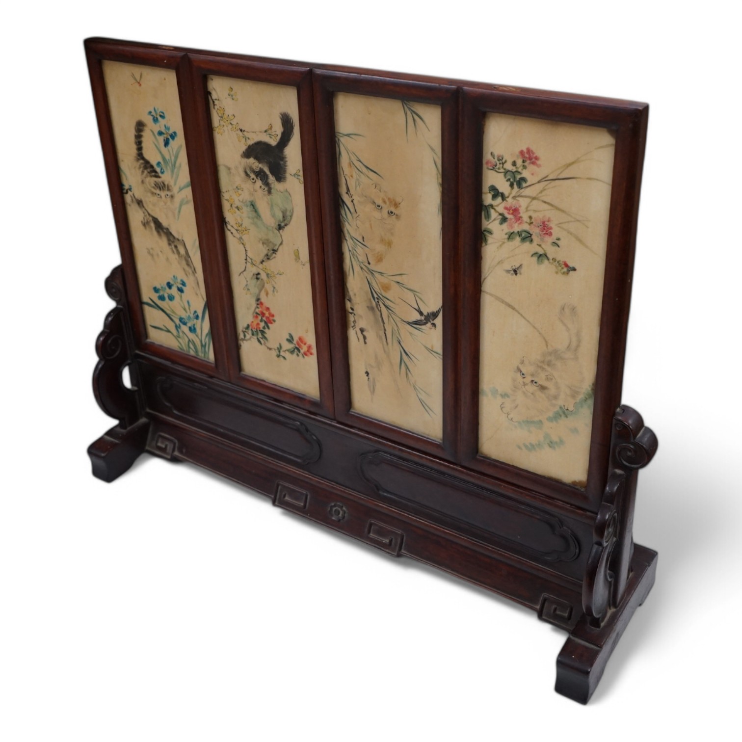 A Chinese four painted porcelain panel and carved hardwood table screen, 54cm wide x 42.5high. Condition - fine staining to one panel and top carved panel of screen missing